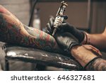 close up tattoo machine. Man creating picture on hand with it in salon