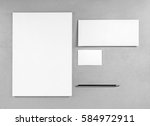 Blank stationery template for placing your design. Photo of blank stationery set. Blank letterhead, business cards, envelope and pencil. Mockup for branding identity. Top view. Grayscale image.