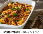 Casserole with minced meat and cabbage on rustic and wooden table 