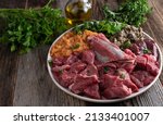 Small photo of Raw dog food, organic and fresh meat, rumen, offal, vegetables, herbs and oil. Healthy meal for pets