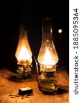 Two Oil Lamps In A Dark House