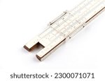 Small photo of Vintage slide rule calculating and measuring instrument. Mechanical analog computing instrument. Isolated on white.