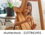 The child plays the harp....