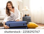 Portrait of beauty asian traveler woman packing stuff and outfit clothes in suitcases travel bag luggage for summer holiday weekend tourist vacation trip at home. travel concept