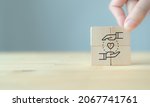 Small photo of Customer relationship management (CRM) or customer loyalty concept. Customer satisfaction, retention strategies. CRM or customer loyalty program banner. Hand put wooden cubes with holding heart icon.