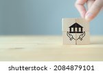 Small photo of Good governance policy concept. Business moral principles concept. Businessman holds the wooden cubes with symbols hand holding the governance on beautiful grey background and copy space.