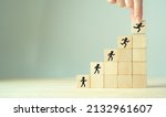 Small photo of Competence skills and personal development concept. Human resource management(HRM). Knowledge, skill training and experience. Wooden cubes stairs with competency development icon on grey background.