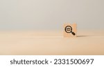 Small photo of Search, Research, Finding Solution, Investigate, Exploratory Concept. Wood block with magnifying glass with eye symbols on grey background, copy space. Marketing research. Customer insight. SEO.