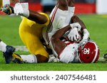 Small photo of Alabama running back Jam Miller #26 is brought down by Michigan linebacker Michael Barrett #23 during the 2024 Rose Bowl game Monday, Jan. 1, 2024, in Pasadena, Calif.