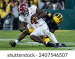 Small photo of Alabama quarterback Jalen Milroe #4 is brought down by Michigan defensive back Makari Paige #7 during the 2024 Rose Bowl game Monday, Jan. 1, 2024, in Pasadena, Calif.