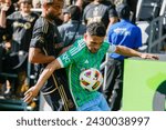 Small photo of Los Angeles FC's Timothy Tillman #11 and Seattle Sounders' Cristian Roldan #7 vie for the ball during an MLS soccer match at BMO Stadium, Feb. 24 2024, in Los Angeles.