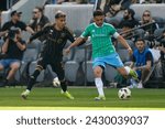 Small photo of Los Angeles FC's Omar Campos #2 and Seattle Sounders' Cristian Roldan #7 vie for the ball during an MLS soccer match at BMO Stadium, Feb. 24 2024, in Los Angeles.