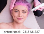 Small photo of closeup photo of woman's face, photo of aesthetics, anti aging procedures. Plasma jet application. Aesthetics, spa. beautician.