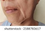 Small photo of portrait showing the wrinkles skin, Flabby sagging and dry skin beside the mouth, blemishes and dark spots on the face, problem wrinkled and flabby skin of the Middle-aged woman, concept health care.