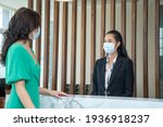 Small photo of Receptionist wearing mask to protect from coronavirus covid 19 are talking customers who come to stay at the hotel.
