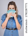 Small photo of woman with Brazilian real money to give away one hundred reais