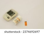 Small photo of Gresik, Indonesia - September 12 2023: Tool for checking uric acid on a white background