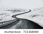 Uphill road landscape in winter at Iceland. Asphalt road with sideways full of snow