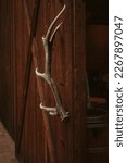 Brown wood barn door with large elk antler shed handle in washington state, winlock washington 