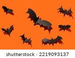 Orange Halloween black paper bats close-up with hard shadows on orange background.Halloween decoration with your own hands, holiday decoration mockup, splash screen.