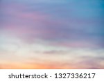 Sunset sky with violet yellow light clouds. Colorful smooth blue sky gradient. Natural background of sunrise. Amazing heaven at morning. Slightly cloudy evening atmosphere. Wonderful weather on dawn.