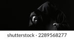 Small photo of Vicious mage in black mantle and demon in sleeve. Ritual deal with devil. Man with split personality. Schizo talking to mask. Cursed assassin end evil spirit in dark room. Monk curse. Evil sorcerer.