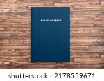 Small photo of Printed and bound Bachelorarbeit (bachelor thesis) in Germany. Book with a blue cover to graduate from a German university with a bachelor degree. Finish studies with a project.