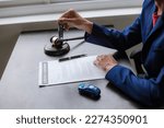Small photo of car auction concept Lawyer working at a table in a court of law The concept of selling a car by auction or fair law.