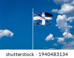 Small photo of The national flag of Greece is waving in the clear blue Greek sky. The white cross symbolises Eastern Orthodox Christianity, the prevailing religion of Greece.