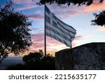 Small photo of The national flag of Greece is waving in the clear blue Greek sky. The white cross symbolises Eastern Orthodox Christianity, the prevailing religion of Greece.