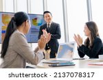 Small photo of Cheerful young Asian businessman Excited and glad applauded. About successful startup projects Happy Asian colleagues celebrating business success in office meeting.