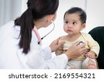 Small photo of An Asian baby girl comes to see a female doctor for a check-up.