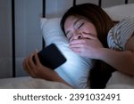 Small photo of Woman playing with phone in dark Stay up late playing on your ce