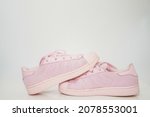 pink sneakers shoes with shoelace side view on floor soft focus with copy space