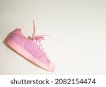pink sneakers shoes with shoelace on floor top view soft focus