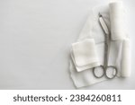 Small photo of Dressing or clean wound tools includes Roll gauze,pile of gauzes and gauze roll cutter or scissors