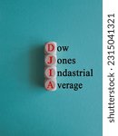 Small photo of DJIA Dow Jones industrial average symbol. Concept red words DJIA Dow Jones industrial average on wooden cubes on beautiful blue background. Business DJIA Dow Jones industrial average concept.