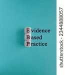 Small photo of Text EBP Evidence-based practice concept on wooden cubes. Beautiful blue background. Business concept.