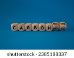 Small photo of From carbon neutral to negative. Turned cubes and changes words carbon neutral to carbon negative. Beautiful blue background, copy space. Business, ecological and carbon negative concept.