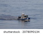 Small photo of Virginia Beach, Virginia, USA - November 10, 2021: A small Virginia Beach Police launch, heads into the Lynnhaven inlet from the Chesapeake Bay