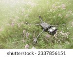 Happy humanoid robot lies on a meadow among wildflowers. Robotic object experiences feelings and emotions. Concept of technology development in the form of artificial intelligence.