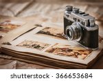 Photo album with photos of travel and vintage old camera on a background of old maps