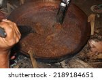 Small photo of the process of making diamonds or lunkhead in a large cauldron