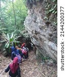 Small photo of Kelantan, Malaysia - Disember 27, 2019 : People are walking down to the surface of the cave to see the condition of the cave in Bukit Panau, Tanah Merah Kelantan