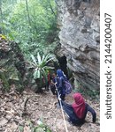 Small photo of Kelantan, Malaysia - Disember 27, 2019 : People are walking down to the surface of the cave to see the condition of the cave in Bukit Panau, Tanah Merah Kelantan