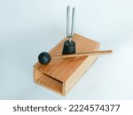 Small photo of A tuning fork is a tool shaped like a two-toothed fork and resonates at a certain frequency when struck on an object. The tuning fork only vibrates at one frequency, with a frequency of 440 Hertz.