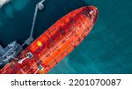 Small photo of Aerial view oil ship tanker vessel loading and unloading in oil terminal station refinery, Global business import export logistic transport sea freight cargo tanker, Red crude oil tanker ship at port.