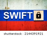 Swift. Russia flag word, lock icon on a wooden block. Blockade. Sanctions. Business. Financial background.