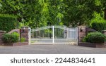 Small photo of Double wrought-iron gate. Wrought iron gate and stone pillar. White wrought iron entrance gates to rural property. Nobody, street photo