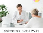 Small photo of Smiling dietician and patient with nutritional problems preparing a diet plan during a meeting